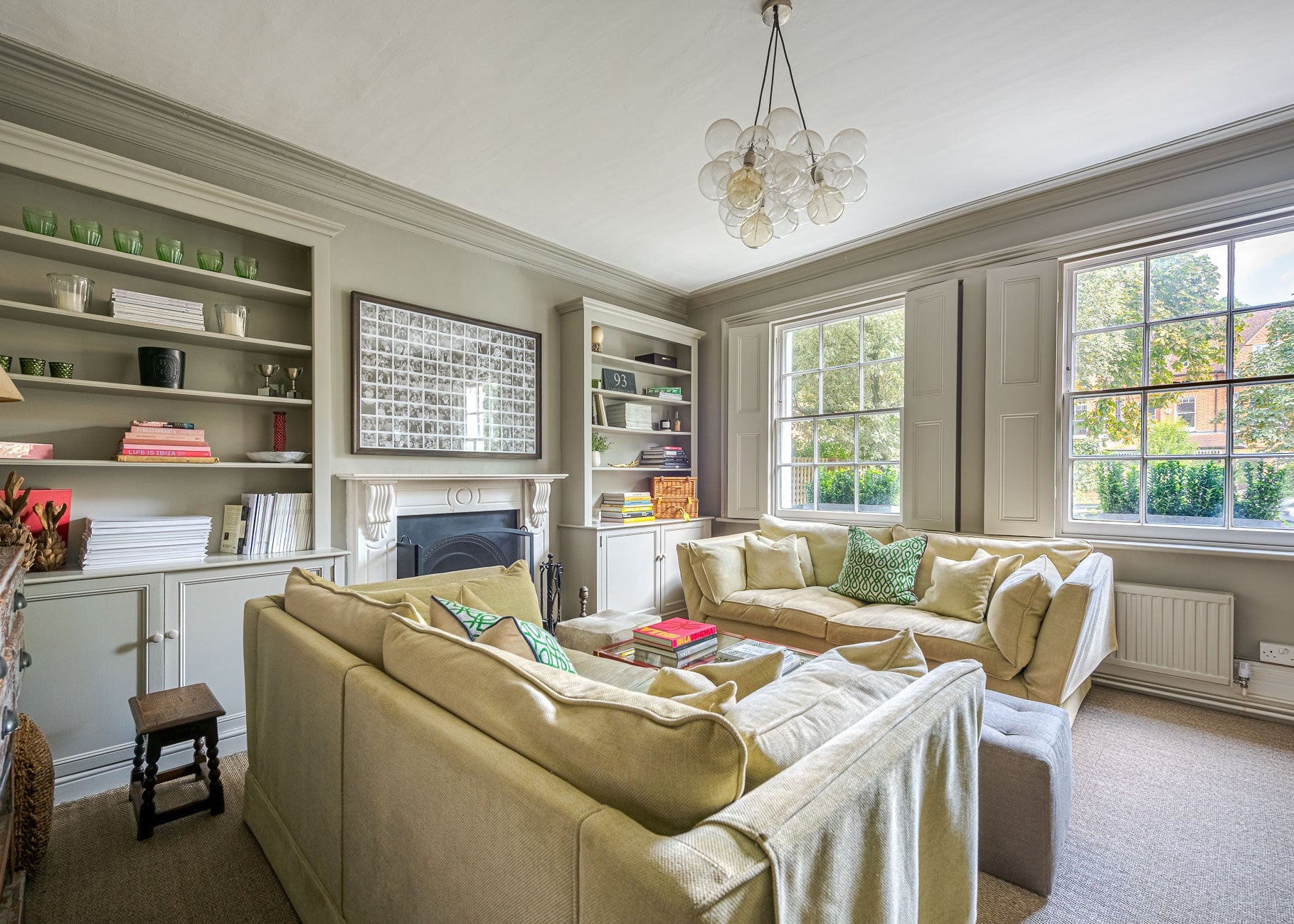 Living room with beige sofa, coffee table, and decorative items.